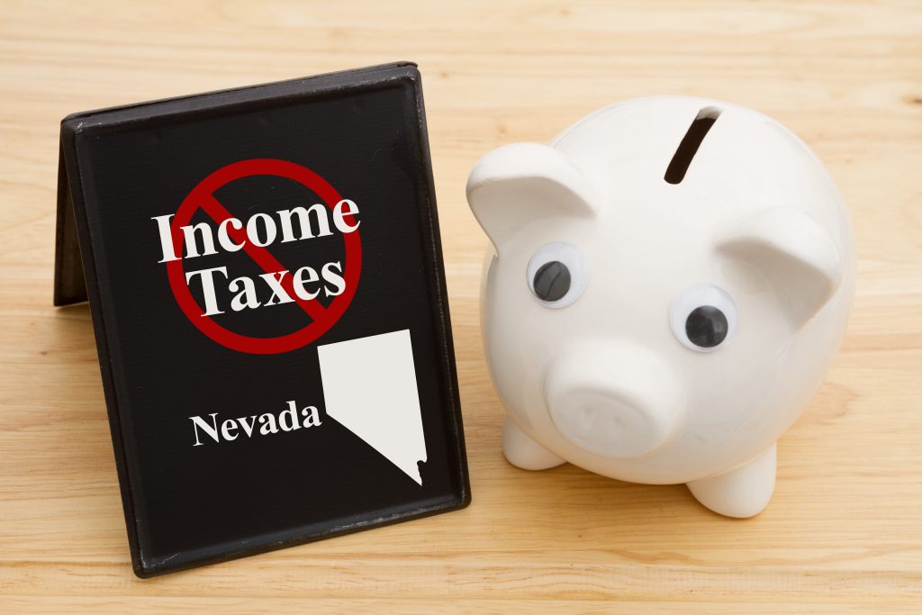 Starting a business in Nevada has the benefit of no personal or corporate income tax as demonstrated by a no income tax sign next to a white piggy bank.